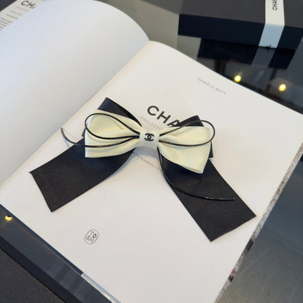 CHANEL 26S BOW HAIR CLIP IN BLACK AND WHITE SATIN 503132