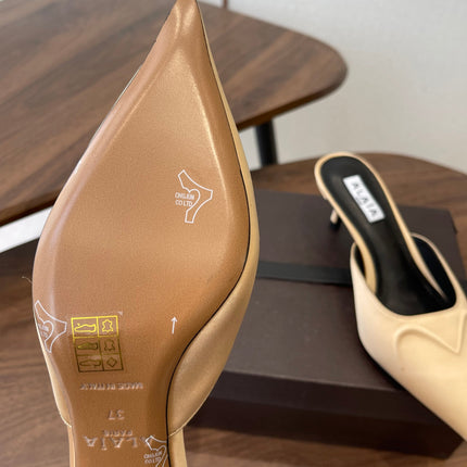 ALAIA 26S HEELED MULES 50 MM IN WARM BEIGE FABRIC