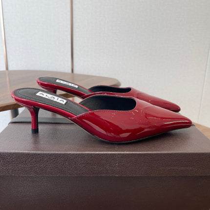 ALAIA 26S HEELED MULES 50 MM IN DARK RED GLOSSY CALFSKIN