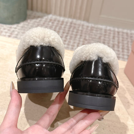 MIUMIU 25S PENNY LOAFERS 20MM IN BLACK PATENT CALFSKIN WITH SHEARLING