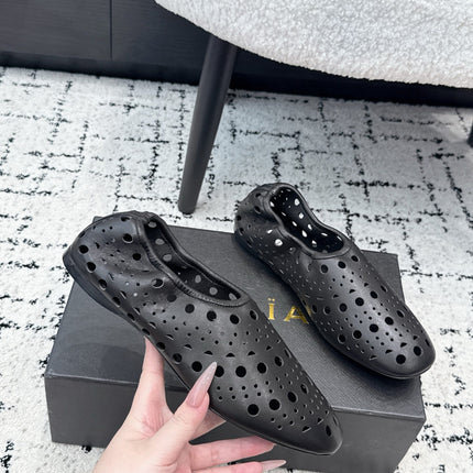 ALAIA 26S FLAT SLIP-ONS IN BLACK CALFSKIN WITH OPENWORK PATTERN