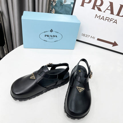 PRADA 26S RUBBER LOGO CHUNKY SOLE FISHERMAN SANDALS IN BLACK CALFSKIN