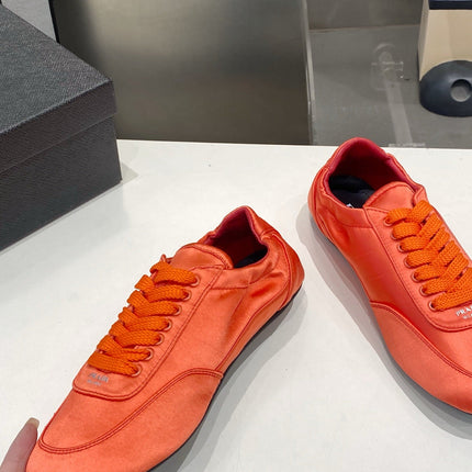 PRADA 26S SNEAKERS IN BURNT ORANGE SATIN