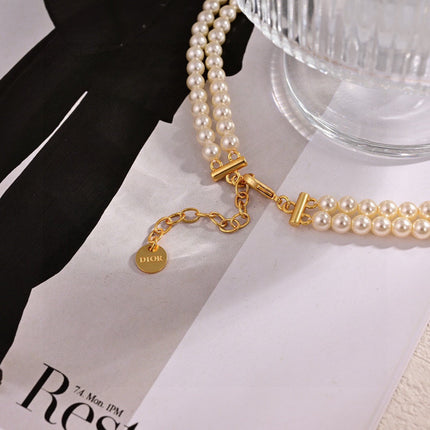 CD 26S PEARL BOW DROP STATEMENT NECKLACE IN GOLD TONE METAL 629848