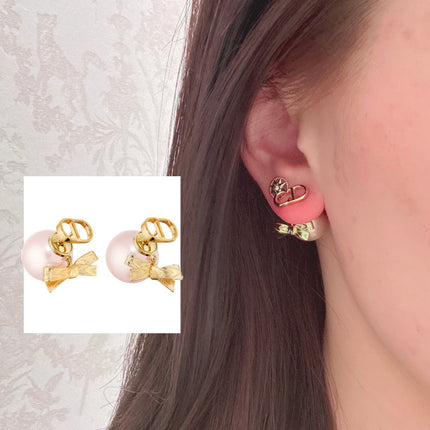 CD 26S PEARL BOW DROP EARRINGS IN GOLD TONE METAL 644484